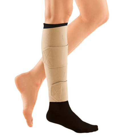 person wearing beige compression wrap on one leg